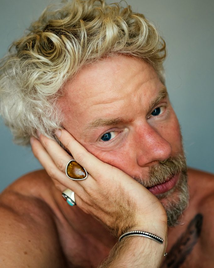 Bare-chested, a direct and unguarded gaze